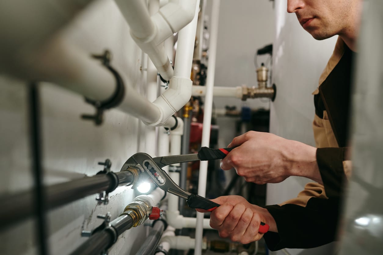 Plumbers maintaining commercial plumbing pipes in Naples