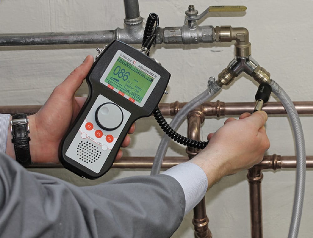 Plumber testing pipes with electronic leak detection equipment in Naples